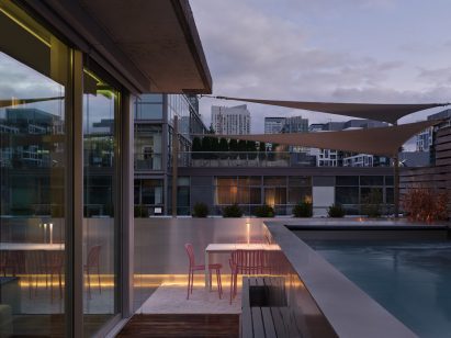 A roof terrace including an outdoor dining area and a raised pool