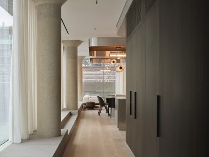 Corridor with dark-stained millwork on one side