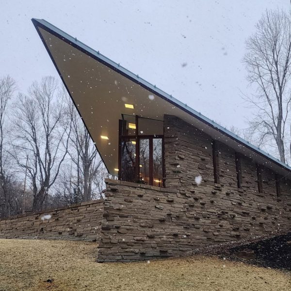 Pointed stone-clad house in the snow