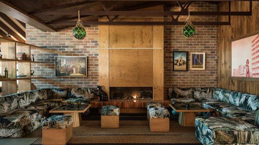Plywood fireplace surrounded by soft seating and shelving