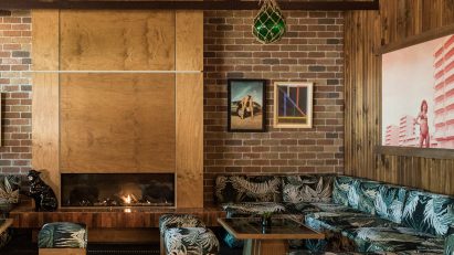 plywood fireplace surrounded by sofas