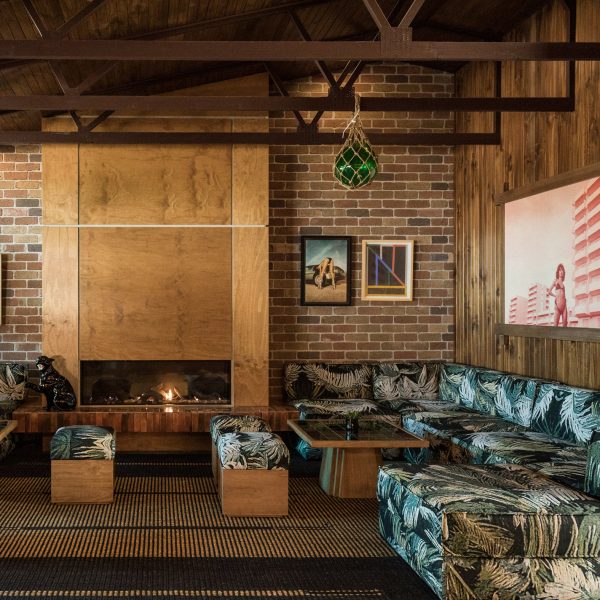 plywood fireplace surrounded by sofas