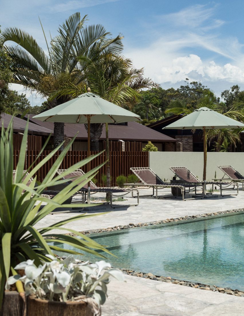 Pool area with loungers and trees