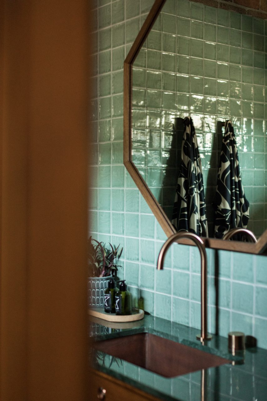Tiled bathroom sink with two patterned robes