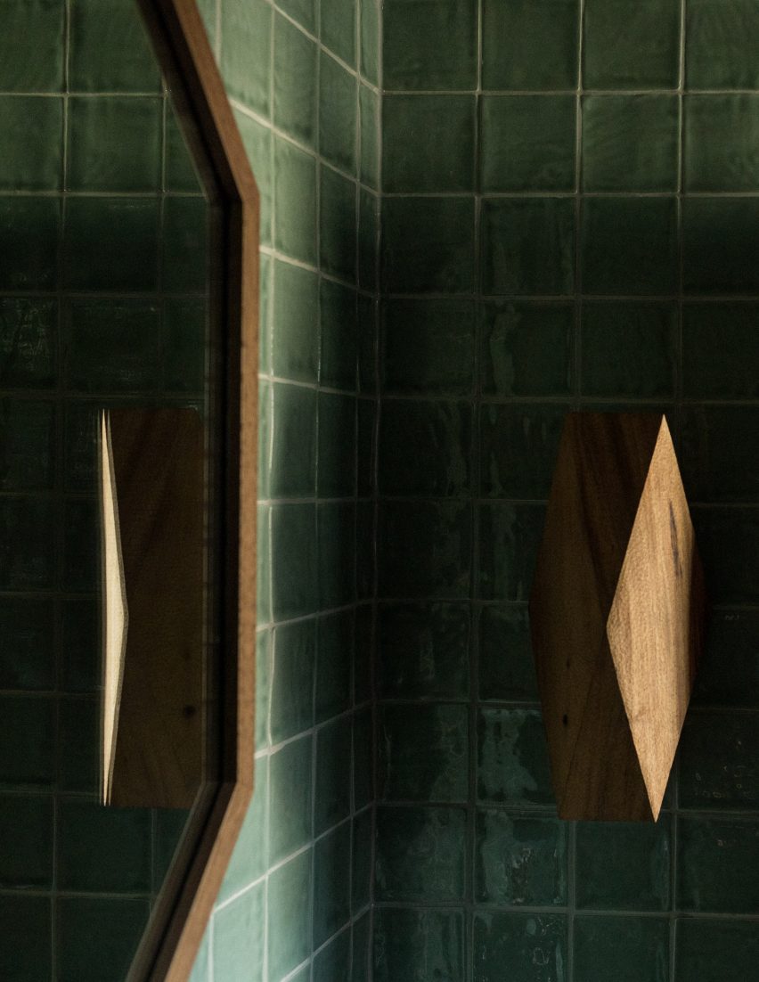 Wooden wall light in tiled bathroom