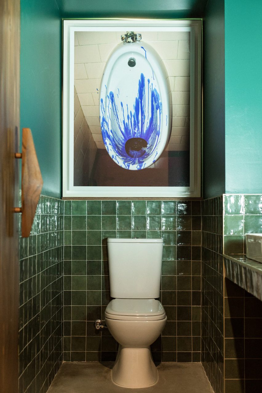 Toilet below photo of urinal