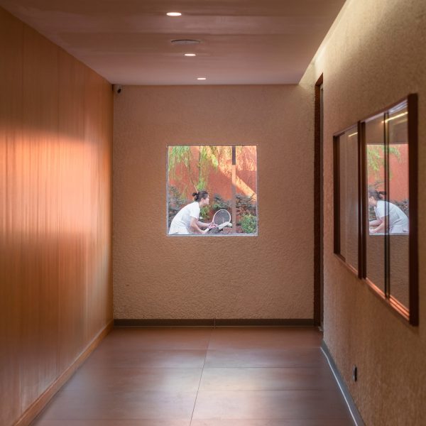 Tennis player viewed through window