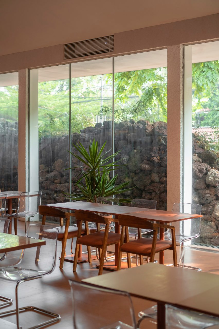 Mounded stones outside glass facade across cafe