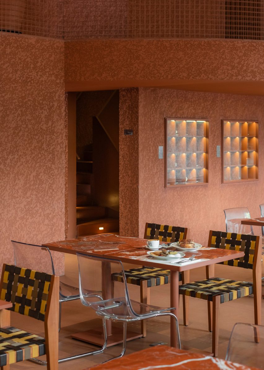 Terracotta walls and woven chairs