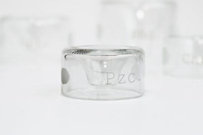 a photograph of a cylindrical object made of translucent material, against a white backdrop