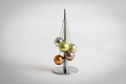 a photograph of a silver ornament in tones of orange and green