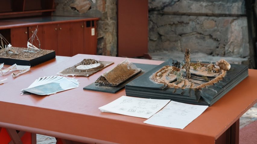 a photograph of physical architectural research placed on a red table