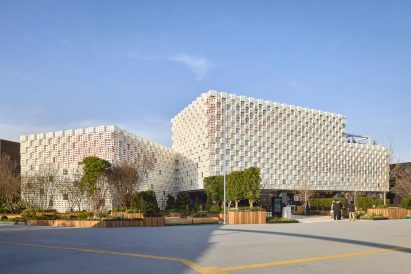 Building with perforated metal facades by Woo Architects