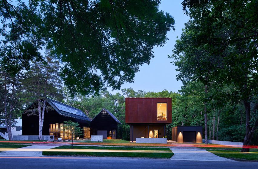 a visualisation of two buildings in tones of red and grey, in a space with green trees and grey pavement surrounding them