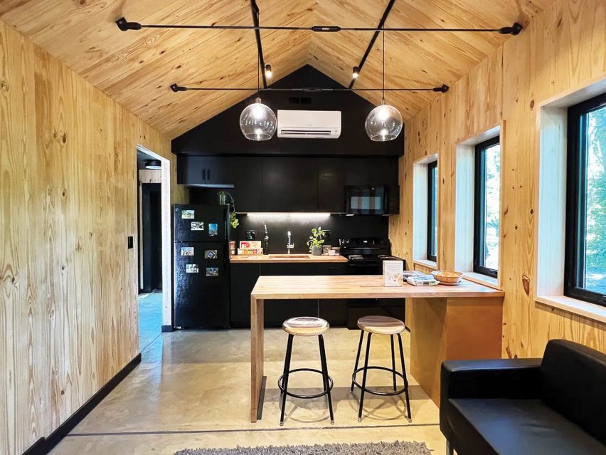 a visualisation of a kitchen, with a wooden panelled ceiling, walls and floor
