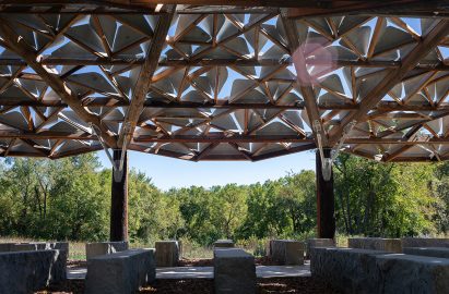 a visualisation of an outdoor pavilion in tones of brown against a blue sky