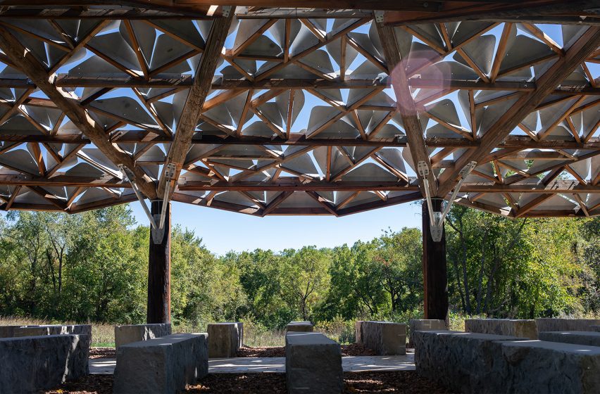 a visualisation of an outdoor pavilion in tones of brown against a blue sky