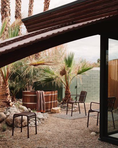 View under a curved roof to a barrel-shaped hot tub and outdoor furniture