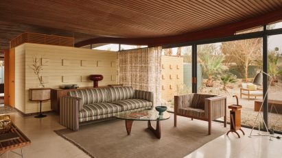 Living room with wavy slatted ceiling and striped furniture