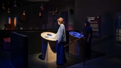 Visitors interacting with touchpoints within the exhibition