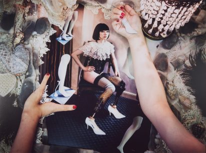 Image of person in fishnet stockings and a lace-like cape
