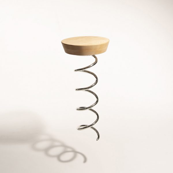 a photograph of a stool design with a wooden seat and a base that is a metal screw, in the style of a corkscrew