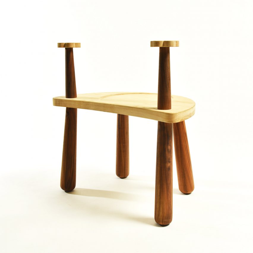 a photograph of a brown wooden stool with elongated legs