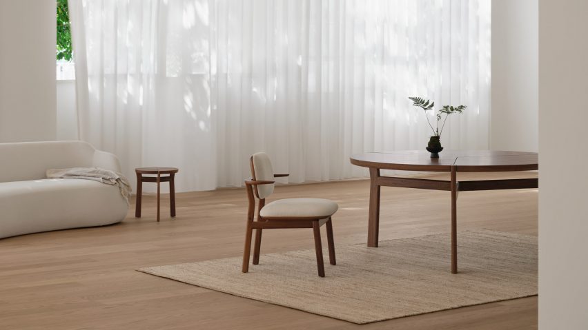 Photo of wooden chair and tables on a beige rug