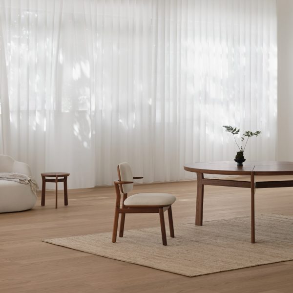 Photo of wooden chair and tables on a beige rug
