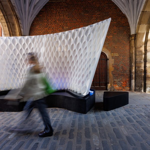 Person walking through St John's Gate archway next to Arthur Mamou-Mani's Harmonic Tides installation