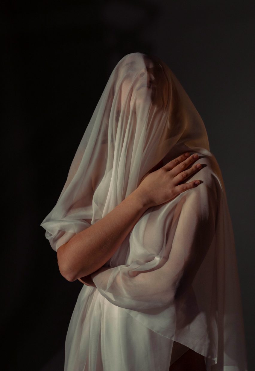 a photograph of a person draped in biege clothing