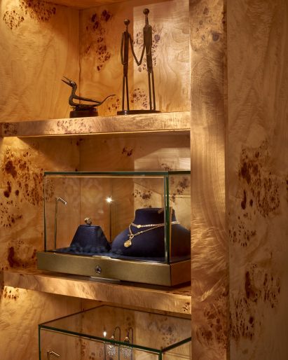 Jewellery displays in burl-wood shelves by Universal Design Studio