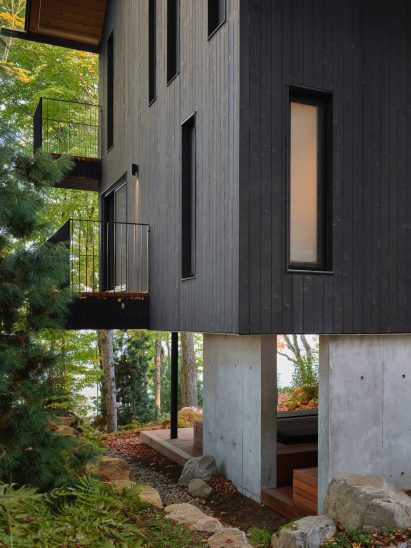Concrete foundation and blackened-wood siding on Muskoka lake house