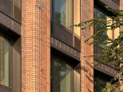 Close-up detail of decorative brickwork on One Park Point building, showing custom-shaped bricks made using a single custom die. The image displays the textured façade with projecting brick elements between windows, demonstrating how the specialised brick creates depth and shadow on the neutral exterior.