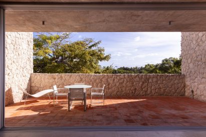 A private balcony featuring a terracotta-tiled floor