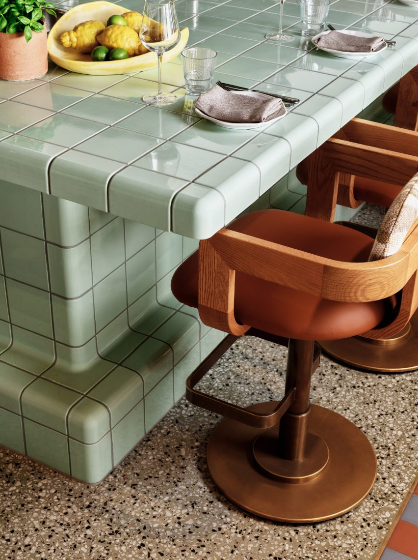 Chair tucked underneath pale green tiled bar top