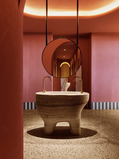Sculptural travertine bathroom vanity