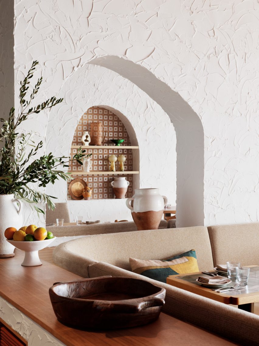 Arch cut into white stucco wall Cibaria Manly