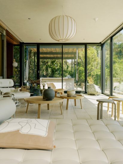 Living room surrounded by floor-to-ceiling glass