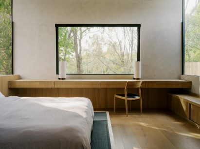 Black tatami mats surround the bed frame in a primary suite