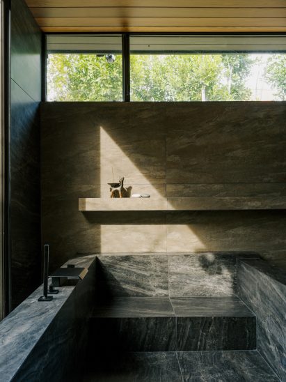 Dark-stone bathroom based on a Japanese ryokan