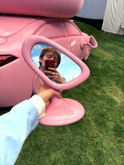 Gustaf Westman holding a pink wing mirror