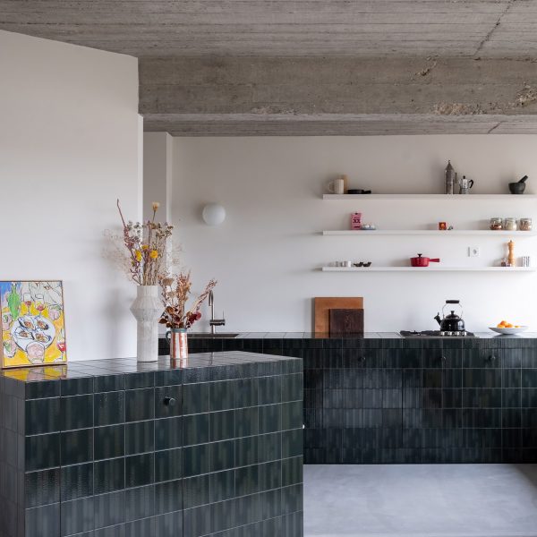 Kitchen clad in blue and green tiles