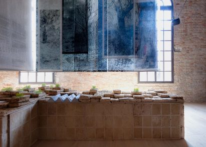 Photo of the Lebanese pavilion with blue monochrome photography printed on textile panels overhanging the space
