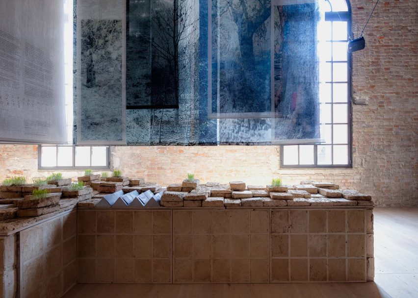 Photo of the Lebanese pavilion with blue monochrome photography printed on textile panels overhanging the space