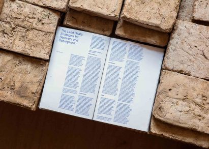 Close-up photo of a text panel at the Lebanese pavilion reading "The Land Heals: Strategies for Recovery and Resurgence"