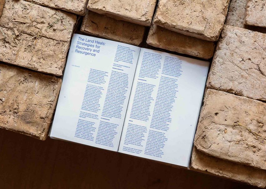 Close-up photo of a text panel at the Lebanese pavilion reading "The Land Heals: Strategies for Recovery and Resurgence"