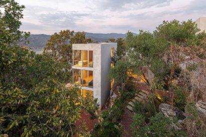 Three bedroom modules stacked to form a tower on a steep site