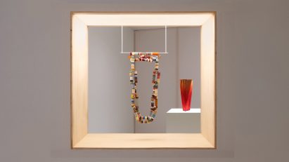 Necklace hanging in an exhibition window