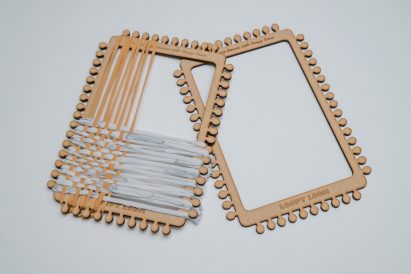 Two laser-cut weaving frames next to each other